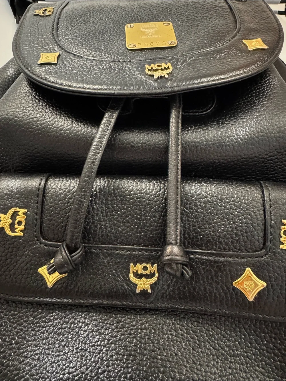 MCM Black Leather Backpack with Gold Logo Accents